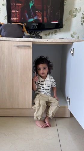 Child found sitting in cupboard under television in India