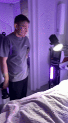 Photographer with camera observed in violet-lit room in Izhevsk