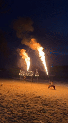 Fire performers stage nighttime beach shows with flaming displays