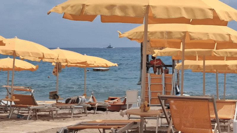 Kites, umbrellas, and a quiet beach morning in Savona