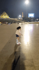 Children rollerblade under crescent moon in Da Lat plaza
