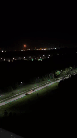 Nighttime scenes captured in Kazan show traffic, moon over waterfront
