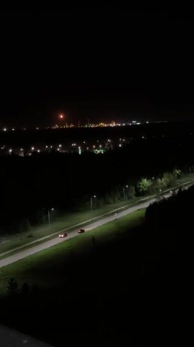 Nighttime scenes captured in Kazan show traffic, moon over waterfront