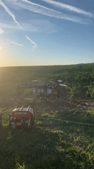 Agricultural drone operates in Bulgarian field during evening hours
