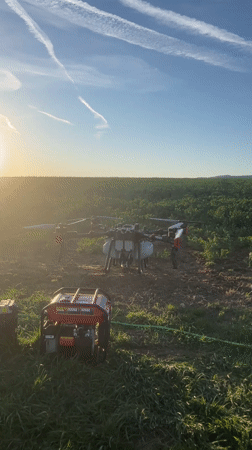 Agricultural drone operates in Bulgarian field during evening hours