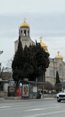 Tourist documents Varna cathedral during afternoon and evening visit