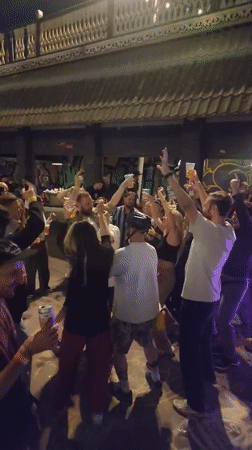 Late-night street gathering with dancing and drinks in Moscow