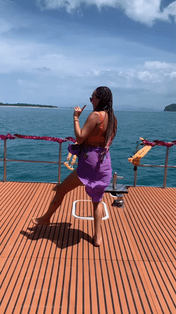Dancing on a boat deck off Ko Samui, phone in hand
