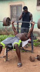 Man bench presses weights in Akwanga, Nigeria
