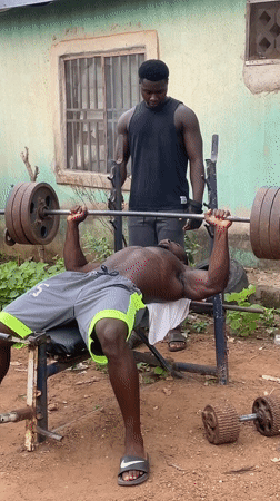 Man bench presses weights in Akwanga, Nigeria