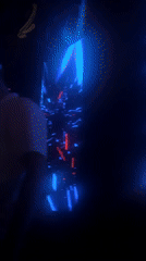 Person dances amid colorful digital light display at indoor venue