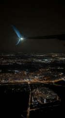 Nighttime aerial view captures illuminated city from aircraft over Vnukovo