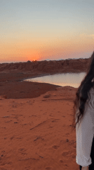 Sunset visitors explore Mui Ne's red sand dunes landscape