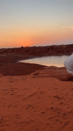 Sunset visitors explore Mui Ne's red sand dunes landscape