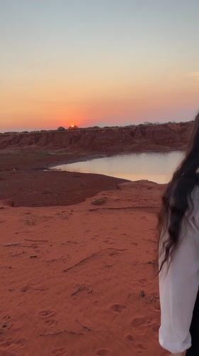 Sunset visitors explore Mui Ne's red sand dunes landscape