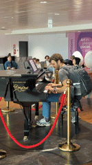 Man plays grand piano in Italian airport terminal