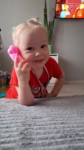 Children play with toy phone, tend to baby in Russian home