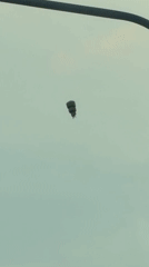 Parachutist spotted descending over Khimki, Russia