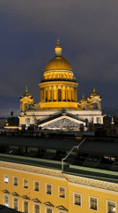 Saint Petersburg's illuminated neoclassical skyline on a wet night