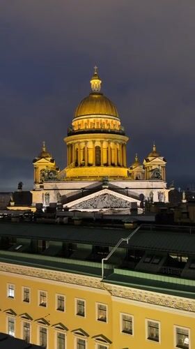 Saint Petersburg's illuminated neoclassical skyline on a wet night