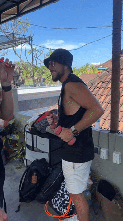 Morning rooftop bar activity captured in Manggis, Indonesia
