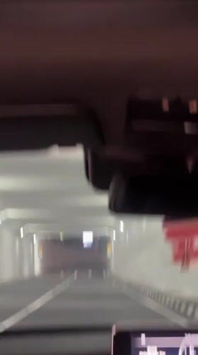 Car drives through lit tunnel in South Jakarta