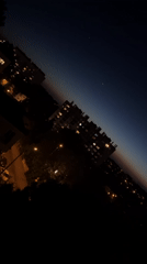 Nighttime cityscape captured with gradient sky and illuminated buildings