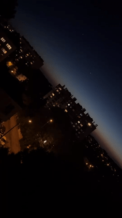 Nighttime cityscape captured with gradient sky and illuminated buildings