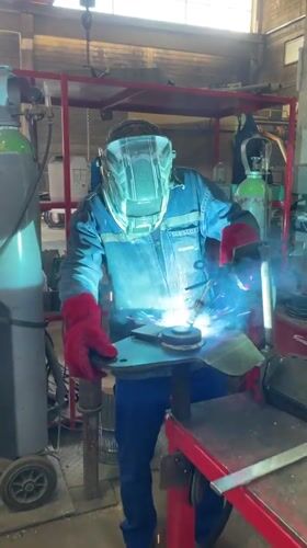 Welder works on metal piece in Montenegro workshop
