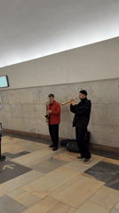Musicians perform near Lenin bust in subway station