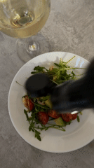 Home cook prepares fresh shrimp salad with wine in Chaikovsky