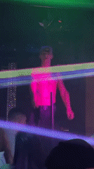Club performer captured under colored lights at venue
