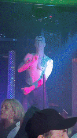 Club performer captured under colored lights at venue