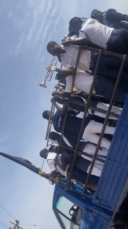 Parade band travels in caged truck bed in Nigeria