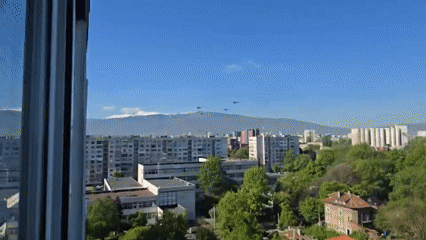 Three helicopters fly in formation over Sofia cityscape