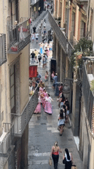 Pink-clad dancers perform in a Barcelona Gothic Quarter alley
