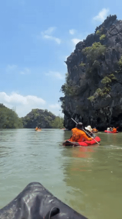 Kayakers explore limestone karsts and mangroves in Krasom Thailand