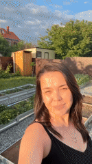 Woman documents afternoon garden activities with pet in Oktyabrsky