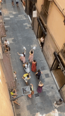 Street performance in a sunlit Barcelona alleyway