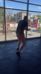 Resistance band and shadow boxing drills in a city-view gym