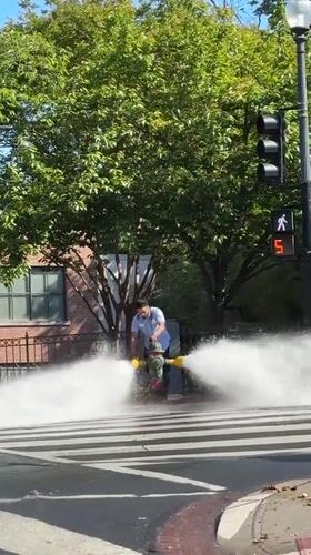 Man operates fire hydrant in Washington crosswalk