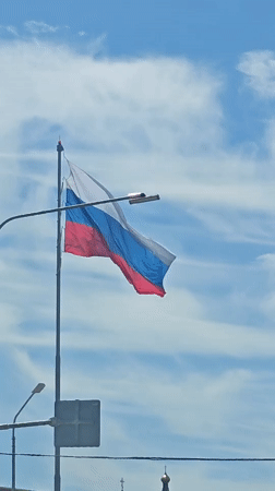 Russian flag flies over Goryachiy Klyuch street scene