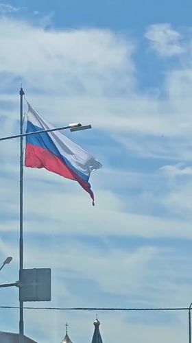 Russian flag flies over Goryachiy Klyuch street scene