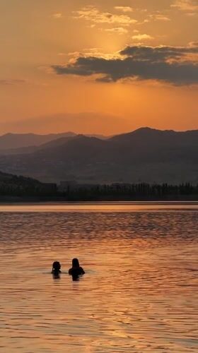 Swimming at golden hour on a calm Tbilisi lake