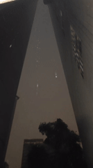 Nighttime rainfall captured between buildings in Yuzhong District, China