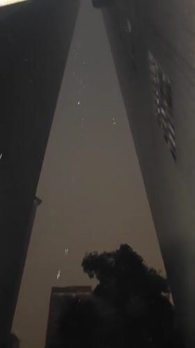 Nighttime rainfall captured between buildings in Yuzhong District, China