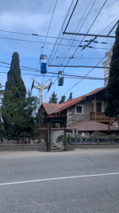 Cable car gondolas spotted in urban street scene