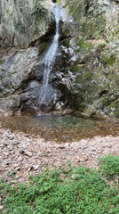 Buddhist cave shrine with waterfall and cairns in Dongducheon-si