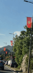 Montenegrin flags displayed along roadway in Cetinje