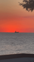 Red sunset over the Adriatic with a ship on the horizon